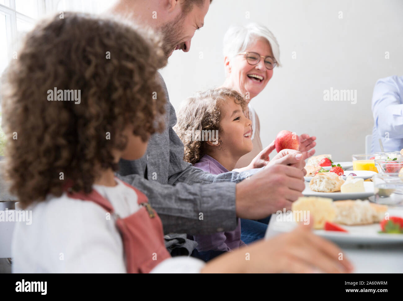 Happy extended family having lunch at home Stock Photo