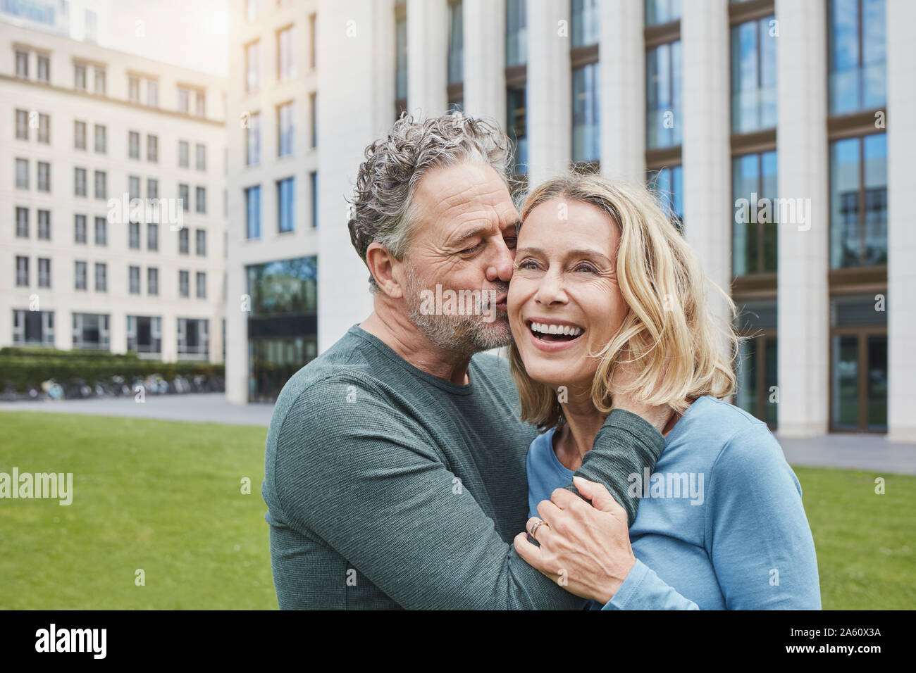 Happy mature couple hugging and kissing in the city Stock Photo