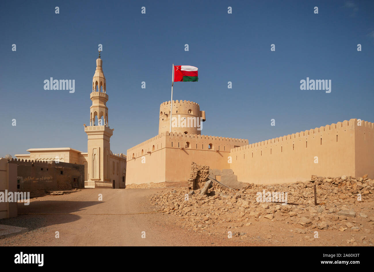 Sultanate Of Oman, Ras al Hadd, Ras al Hadd Castle with Omani flag and minaret Stock Photo