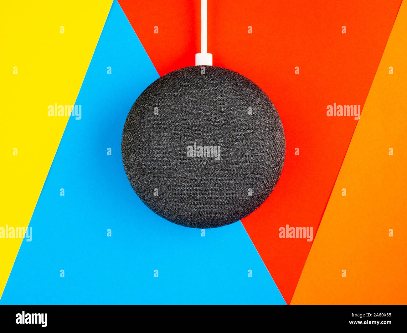 Smart home device speaker on bright coloured background Stock Photo