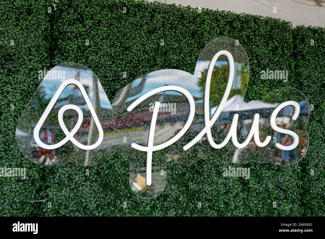 Close-up of logo for AirBNB Plus, a division of sharing economy vacation rental company AirBNB focusing on higher-end homes, against a green wall in Lafayette, California, September 22, 2019. () Stock Photo