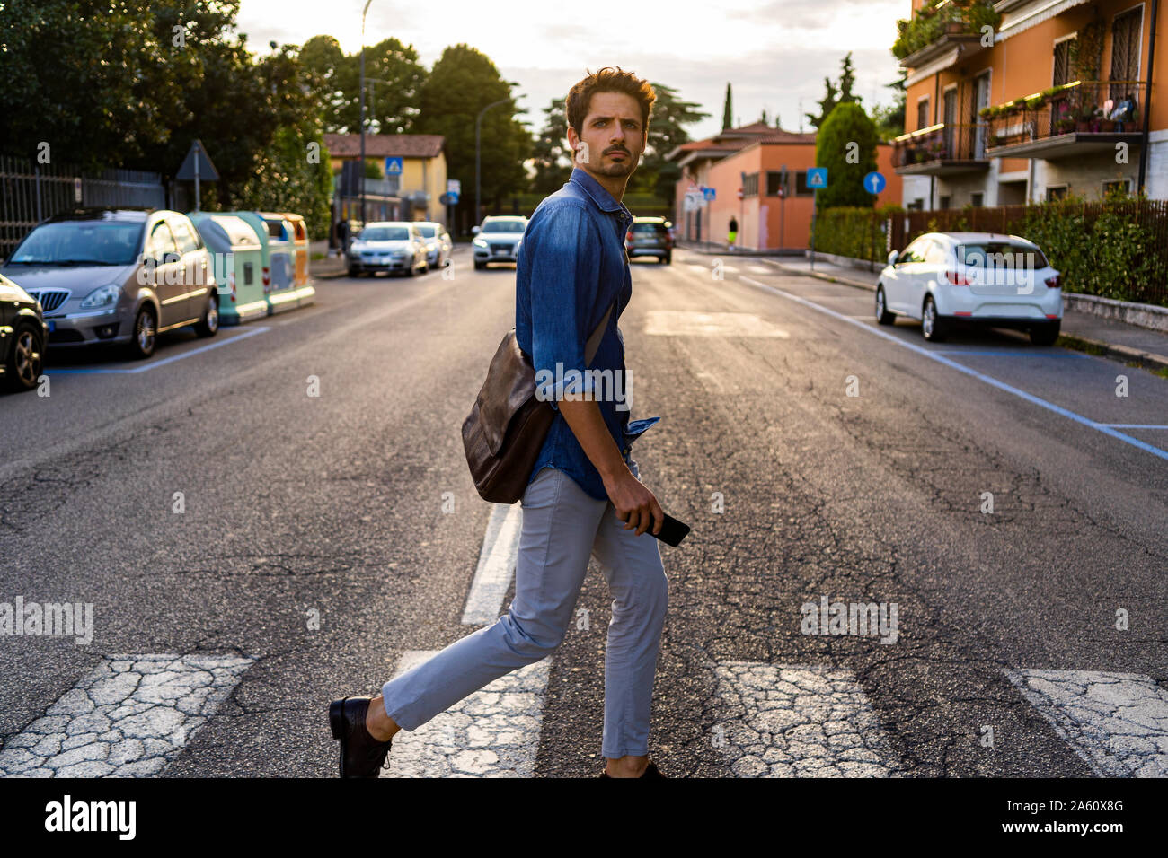 Man crossing street in the city Stock Photo