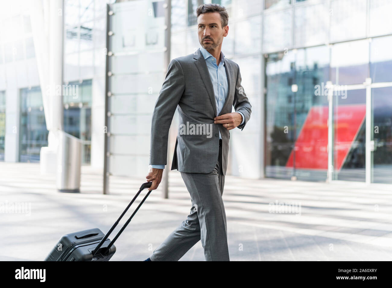 Businessman with baggage on the go Stock Photo