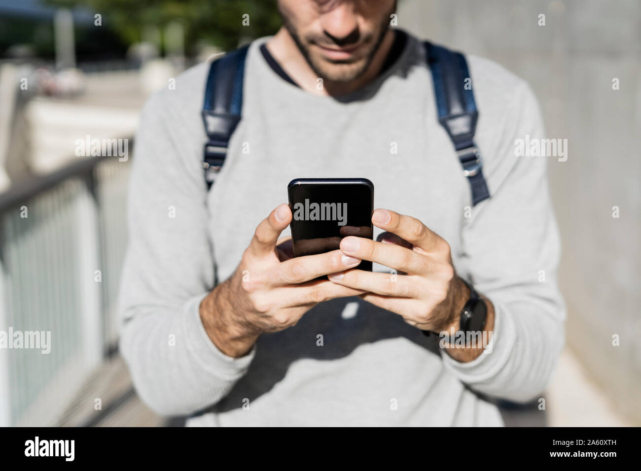 Close-up of man using smartphone in the city Stock Photo
