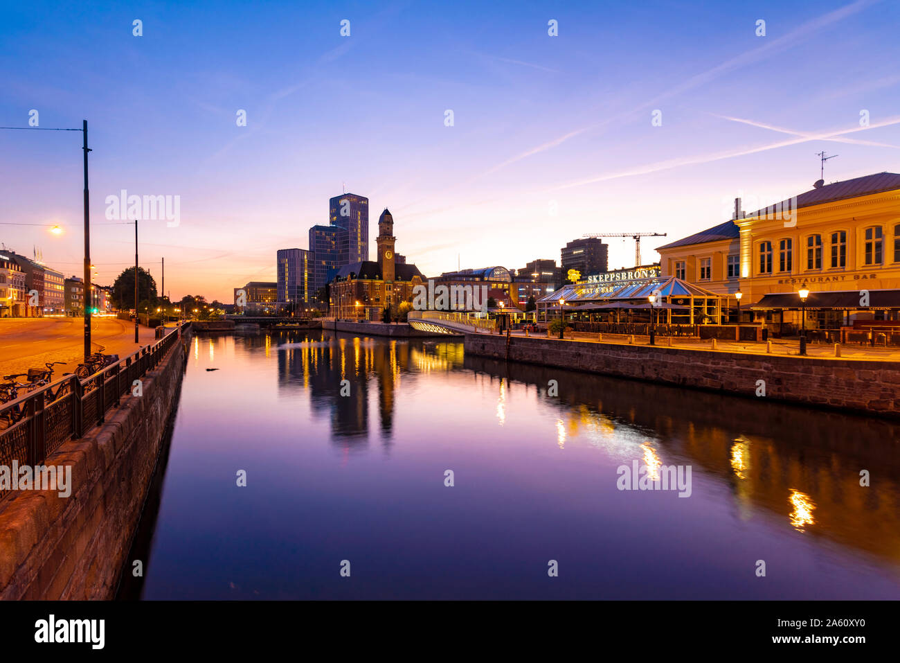 Buildings by canal against sky at dusk in Malmo, Sweden Stock Photo