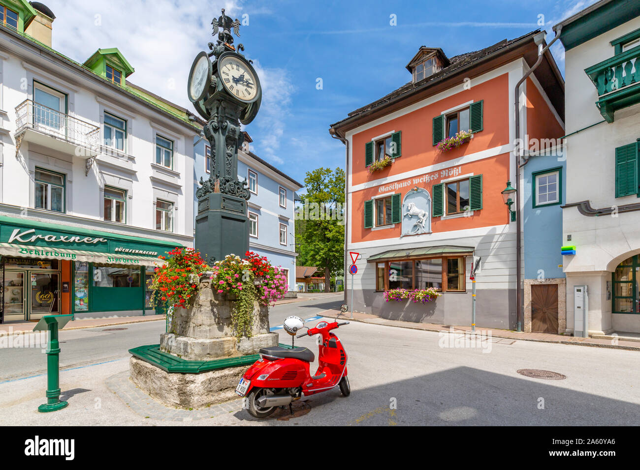 View of colourful buildings, red scooter and main street in Bad Aussie, Styria, Austria, Europe Stock Photo