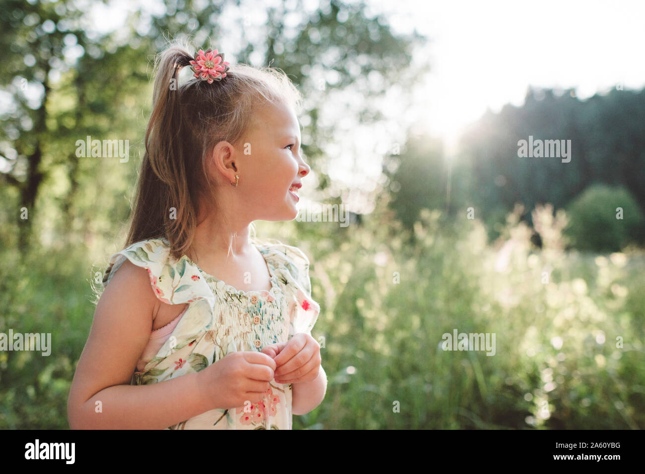 Smiling little girl in nature Stock Photo - Alamy