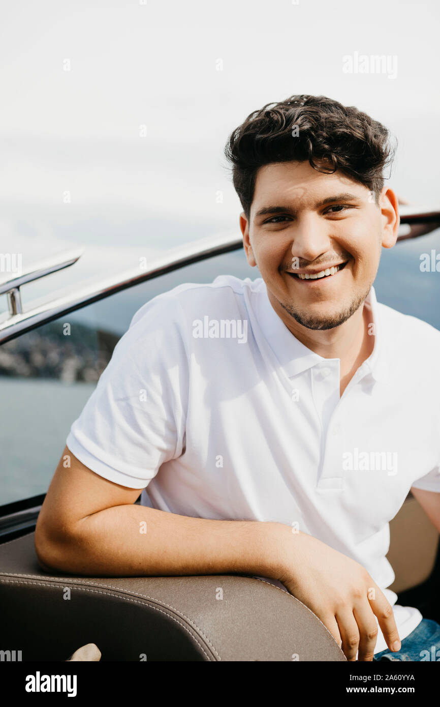 Portrait of happy man on a boat trip on a lake Stock Photo