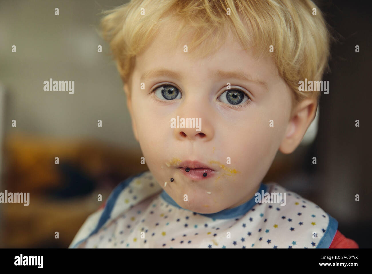 Portrait of blond little boy eating caviar and egg Stock Photo