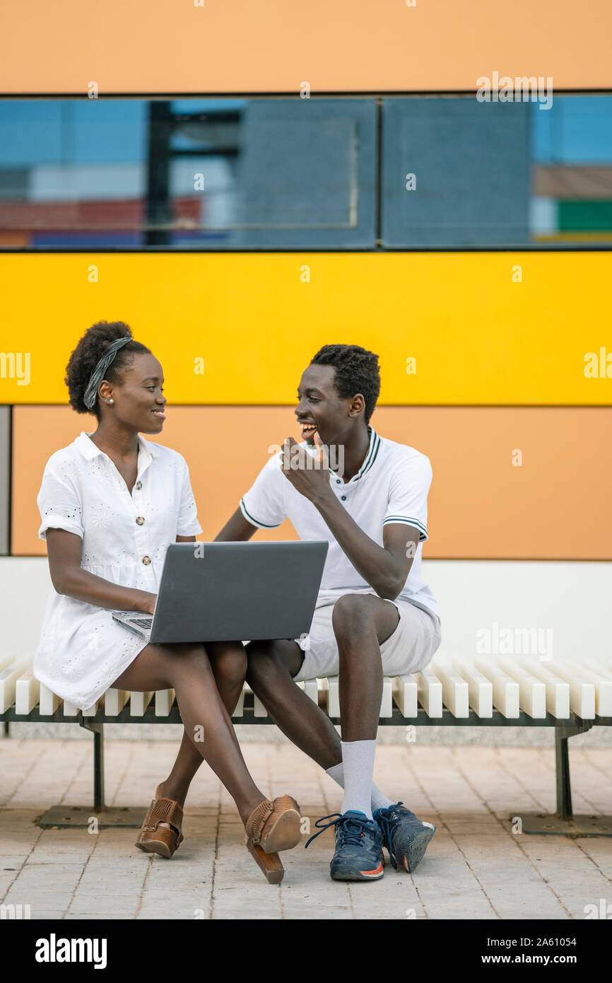 Positive black couple sitting hi-res stock photography and images - Alamy