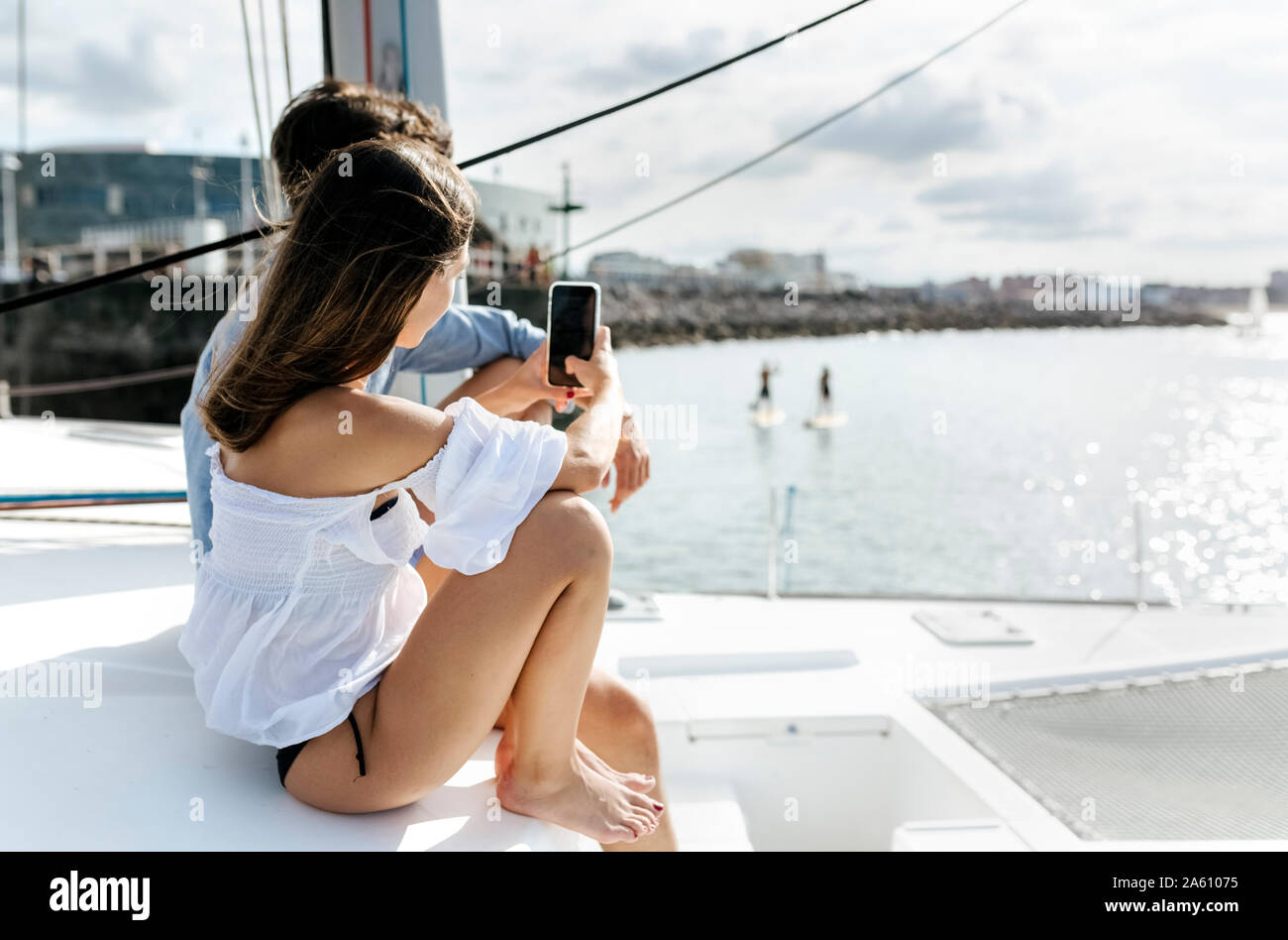 Young couple enjoying a summer day on a sailboat Stock Photo