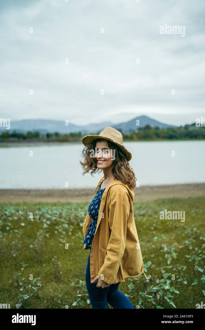 Young woman wearing yellow coat Stock Photo - Alamy