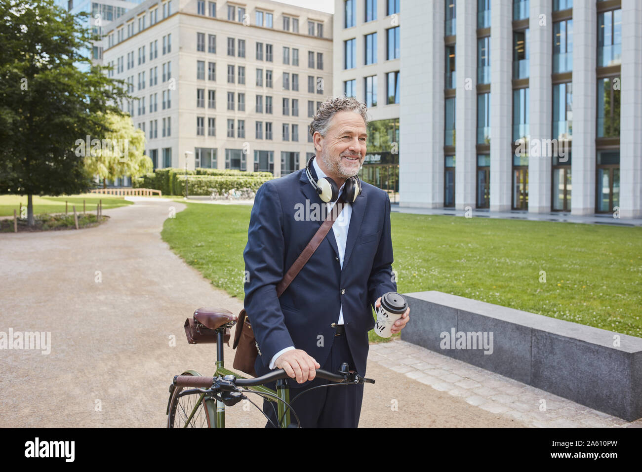 Mature businessman with bicycle in the city Stock Photo