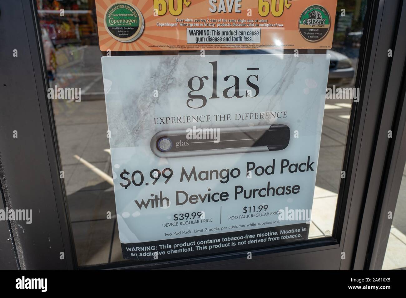 Close-up of sign for Glas nicotine vaporizer, used for vaping, with text advertising fruit flavors including a mango flavor, at a convenience store in San Ramon, California, September 25, 2019. () Stock Photo