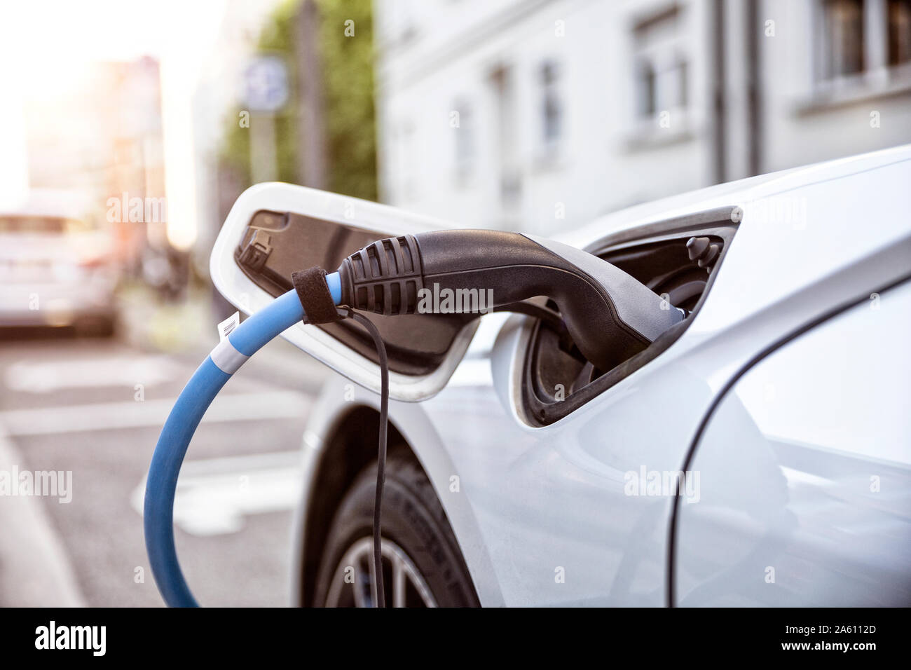 Electric car gettig charged at an charging station Stock Photo