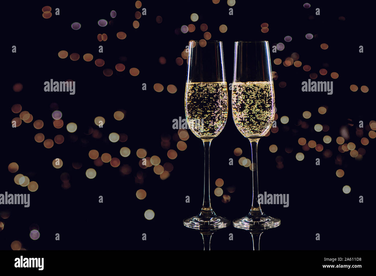 Two champagne glasses clinking hi-res stock photography and images - Alamy