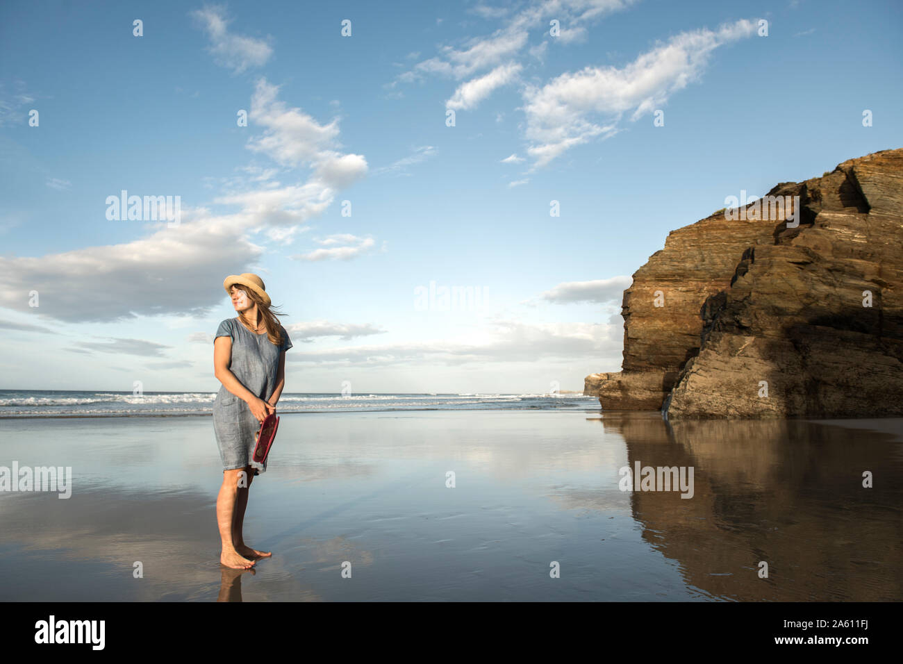 Woman standing on beach looking at sea hi-res stock photography and ...