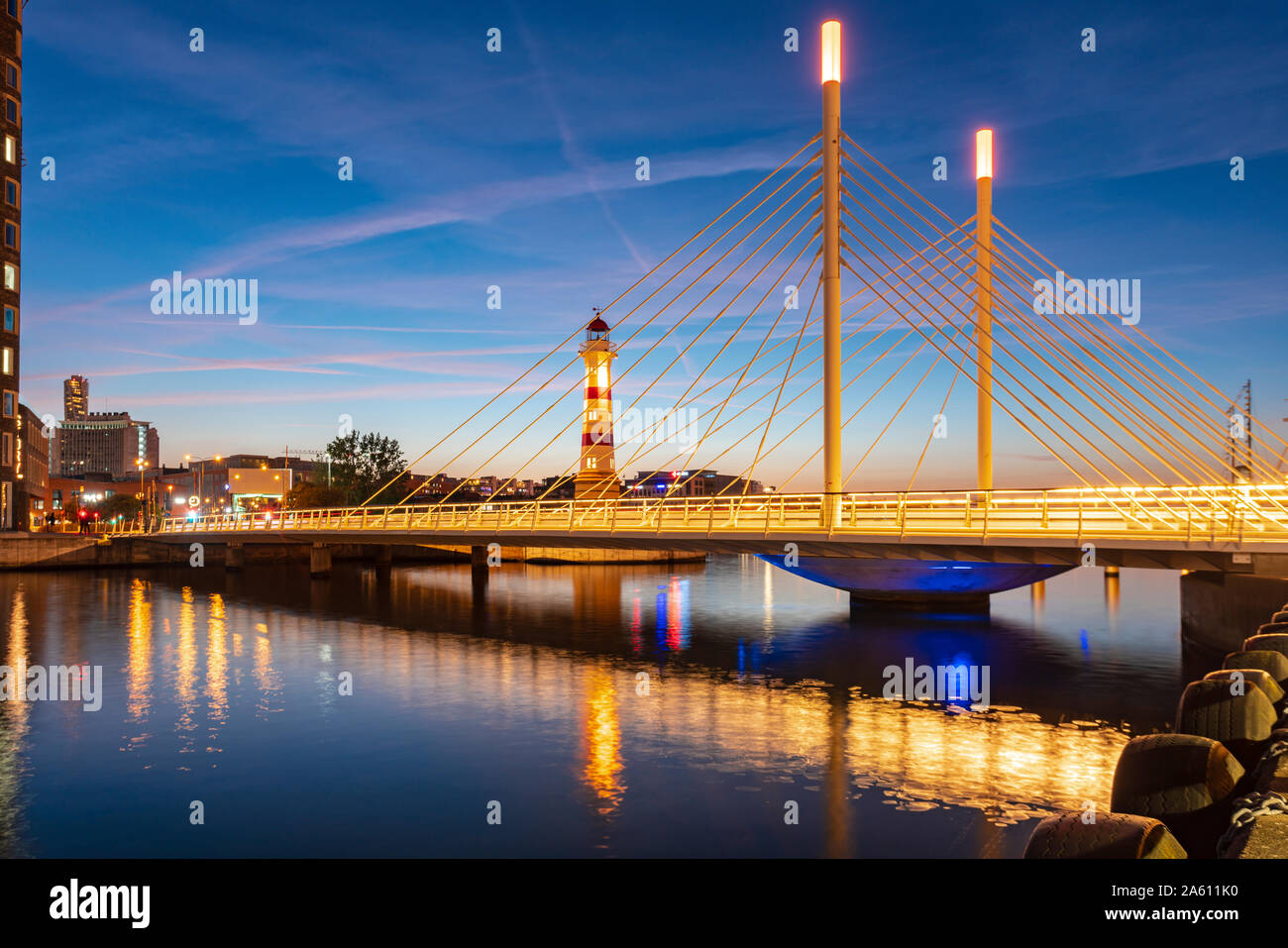 Illuminated bridge over river against sky at Malmo, Sweden Stock Photo