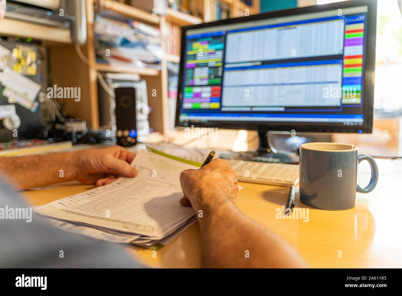 Senior man working in office, using computer Stock Photo