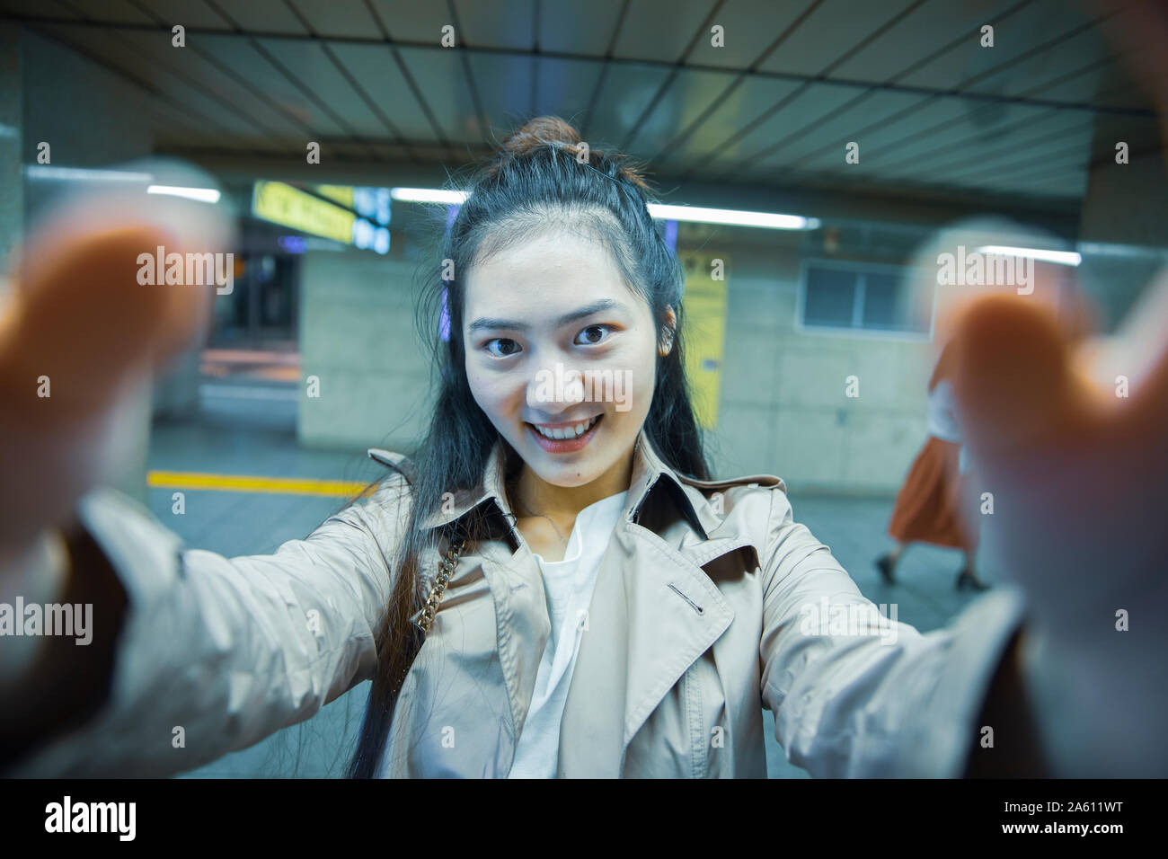 Selfie portrait of smiling young woman at Ginza underground station, Tokyo, Japan Stock Photo