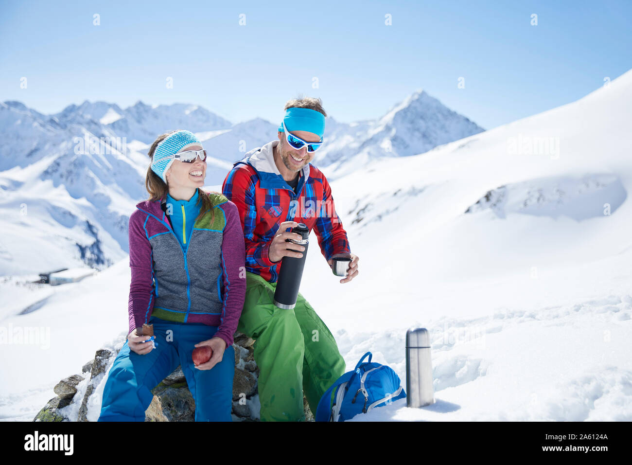 Happy youple of ski tourers having a break in the mountains, Kuehtai, Tyrol, Austria Stock Photo