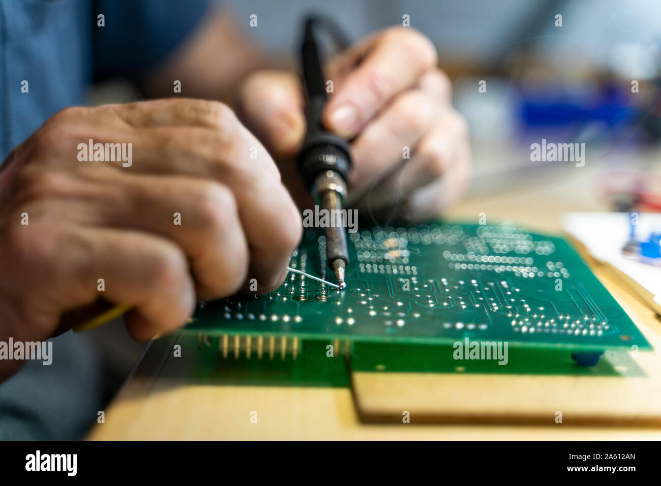 Senior man working on electronic circuits in his workshop, close up Stock Photo
