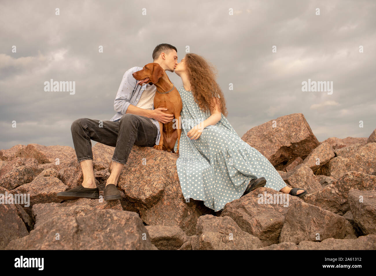 Young couple with dog at the beach Stock Photo - Alamy