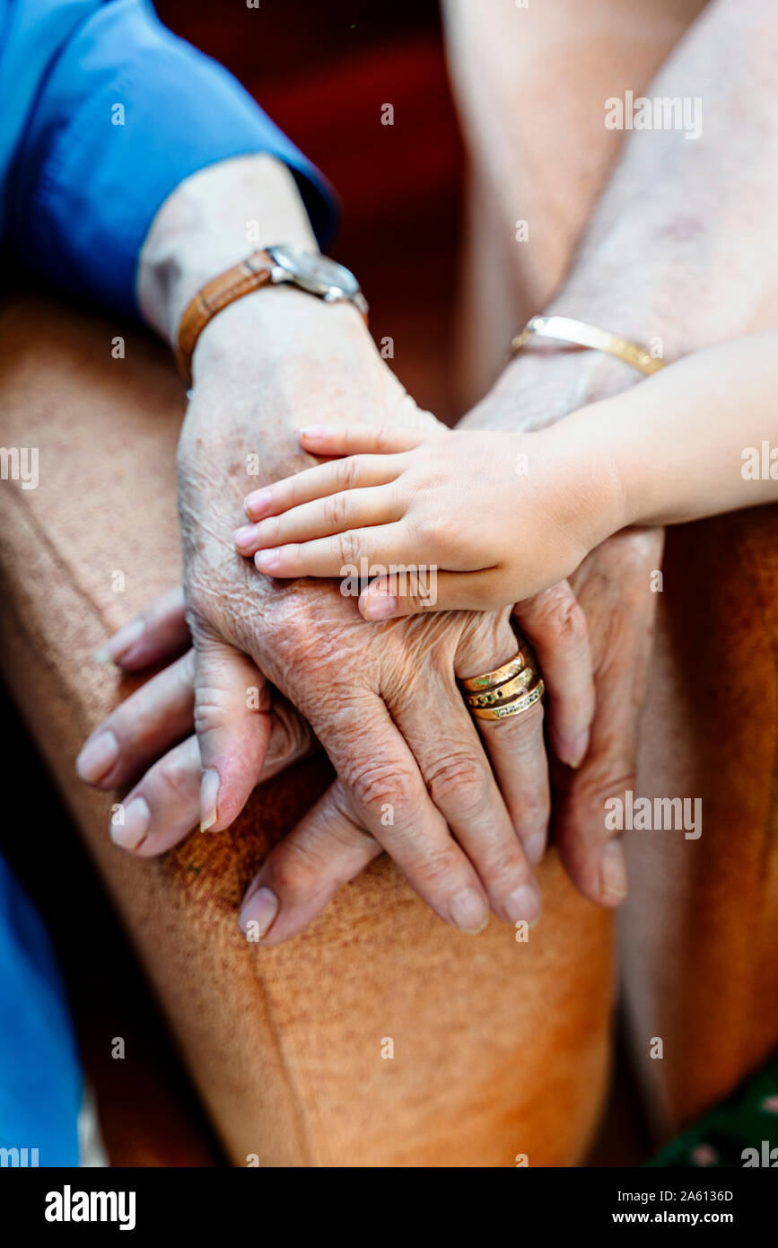 Elderly couple and baby's hand, generations together Stock Photo
