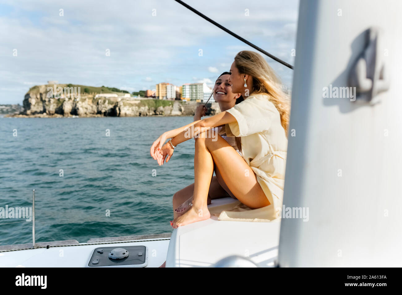 Two beautiful women enjoying a summer day on a sailboat Stock Photo