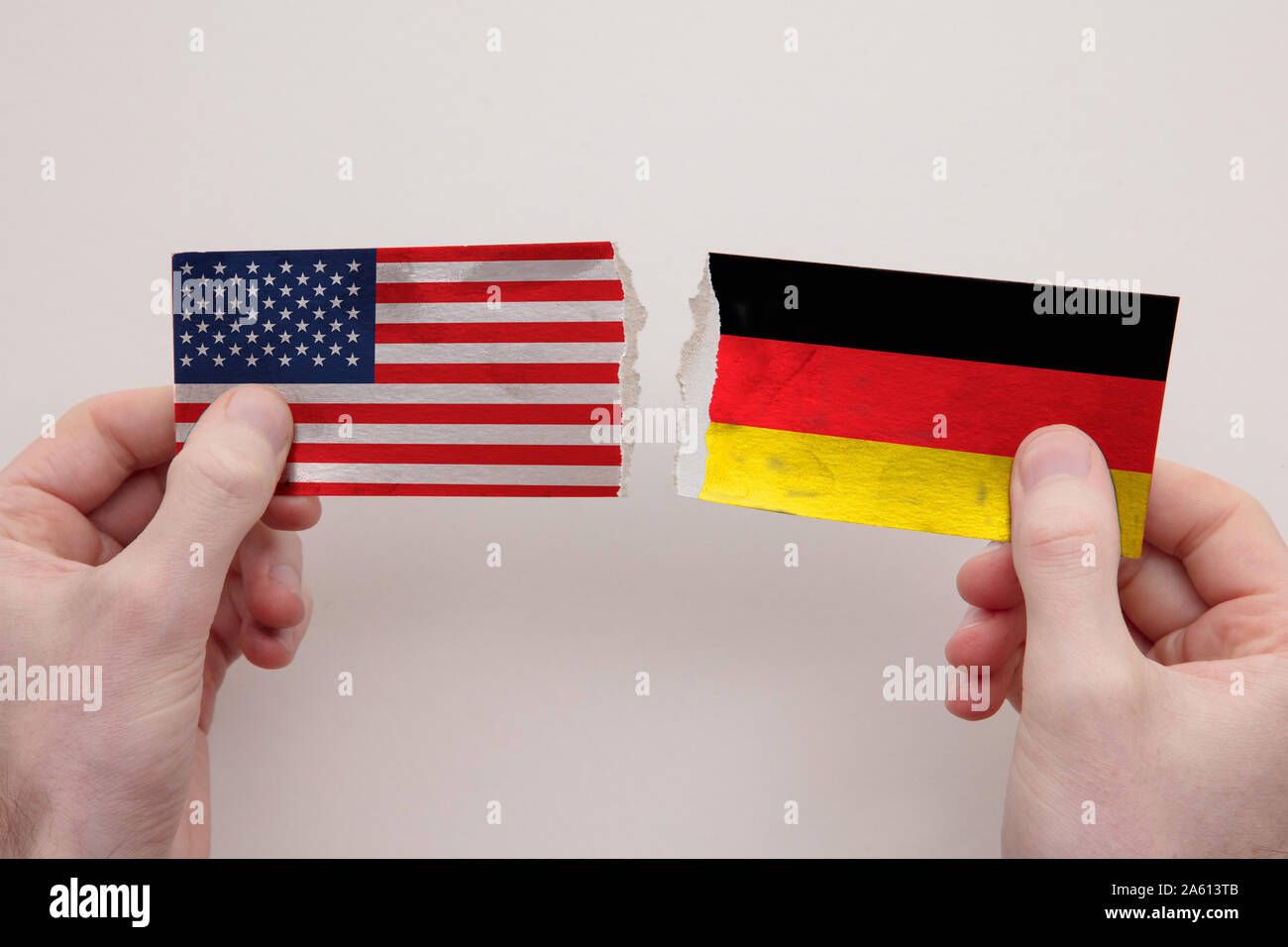 USA and Germany paper flags ripped apart. political relationship concept Stock Photo