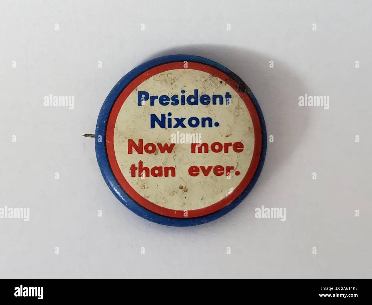 Close-up of pinback campaign pin for election of President Richard Nixon on white background, 1970. () Stock Photo