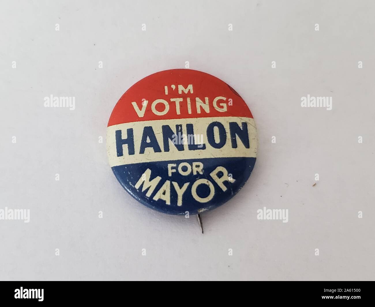 Red, white, and blue campaign pin-back button or badge, with the text 'I'm Voting Hanlon For Mayor, ' manufactured in the United States of America, 1965. () Stock Photo