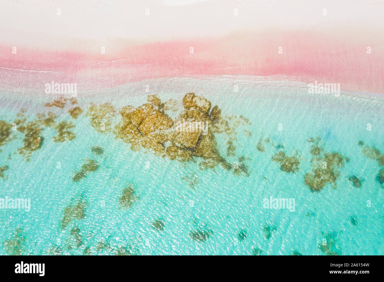 Waves of turquoise sea crashing into pink sand beach from drone above, Caribbean, Antilles, West Indies, Caribbean, Central America Stock Photo
