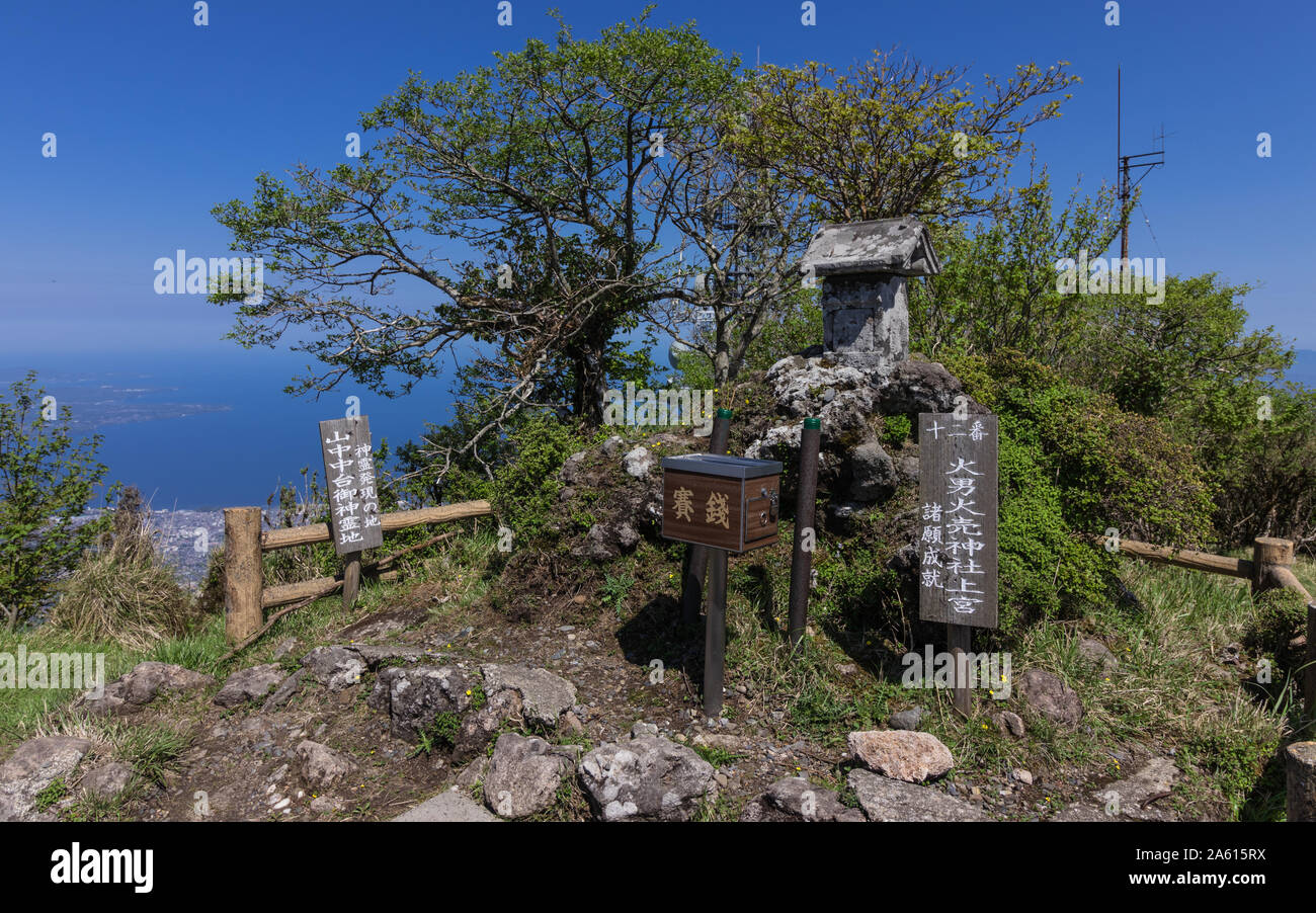 Buddha Statue Number 12 with explanation sign of the Buddha Path on the Top of Mount Tsurumi. Beppu, Oita Prefecture, Japan. Stock Photo