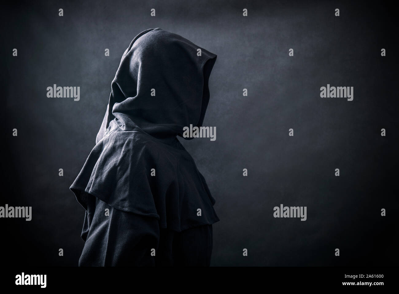 Scary figure in hooded cloak Stock Photo