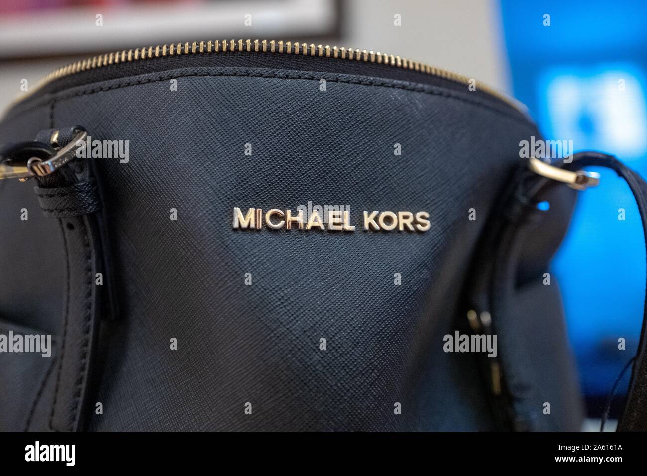Close-up of logo for apparel company Michael Kors on a black leather handbag in a domestic room, August 21, 2019. () Stock Photo