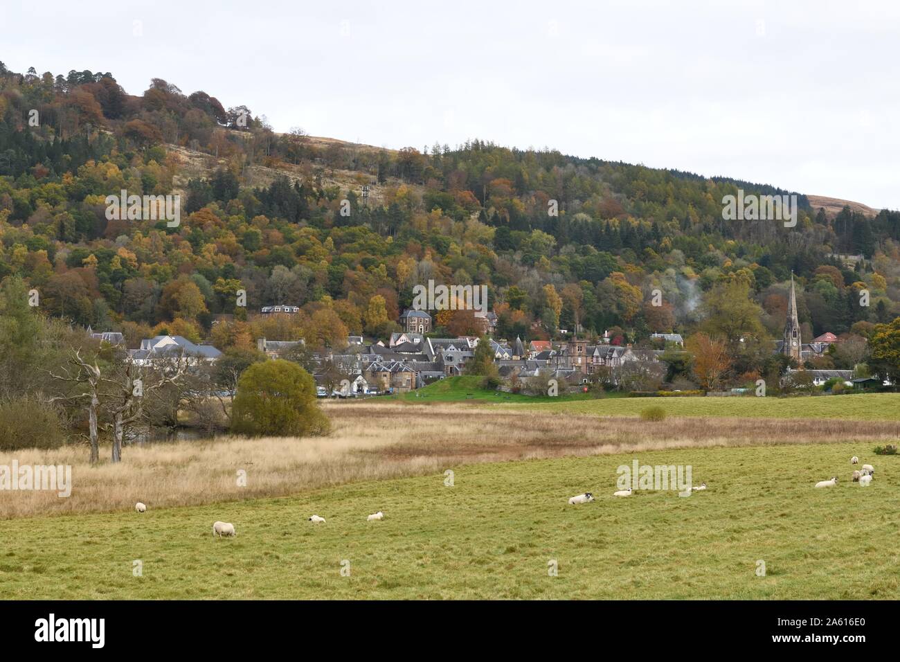The Scottish town of Callander nestled between the Autumn leaved Callander Crags and the river Teith, in Stirlingshire, Scotland, UK, Europe Stock Photo