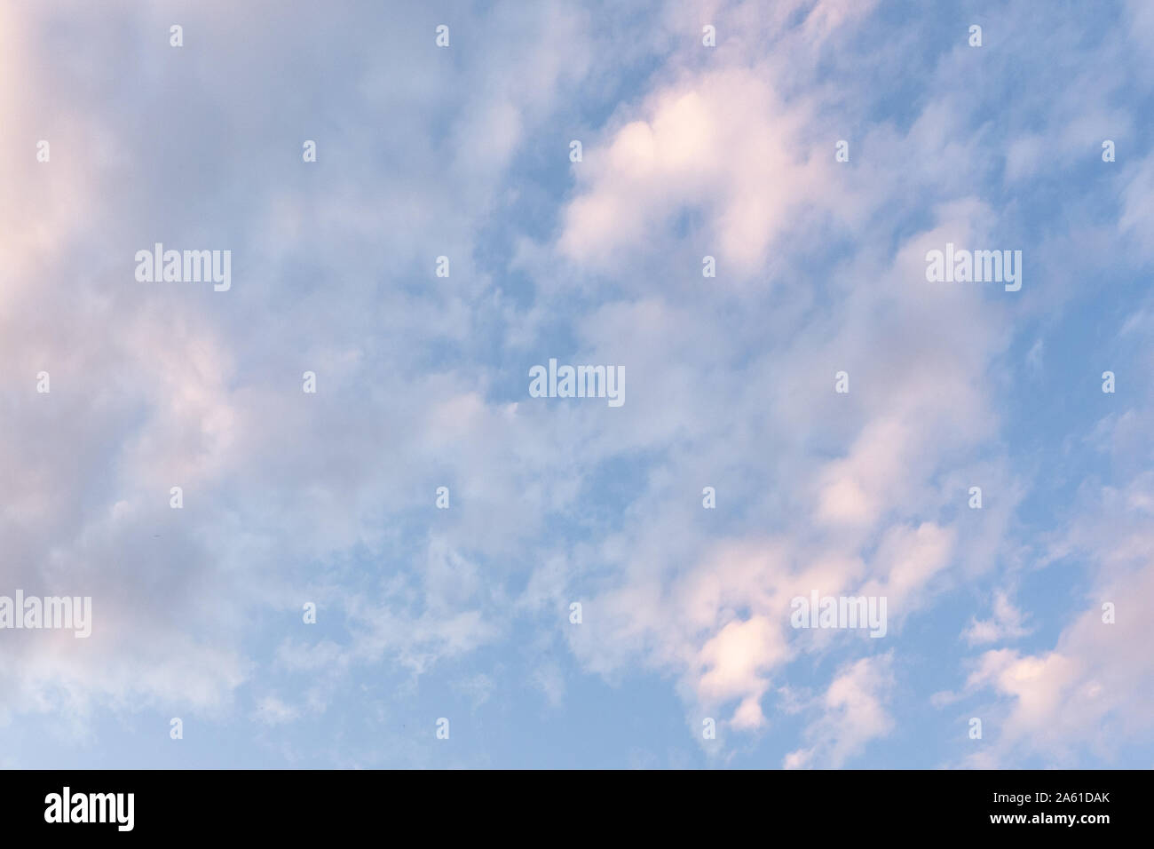 many calm clouds in the light blue sky, background. Stock Photo