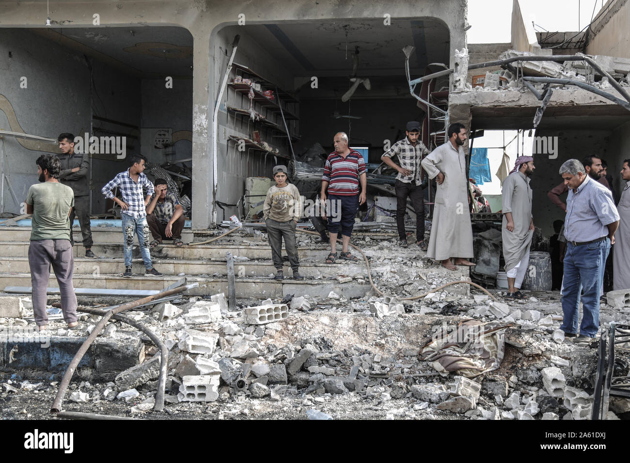 Suluk, Syria. 23rd Oct, 2019. People inspect the damage resulted from an attack by a car bomb at a popular market which resulted in the death of three people, while several others were injured. Credit: Anas Alkharboutli/dpa/Alamy Live News Stock Photo