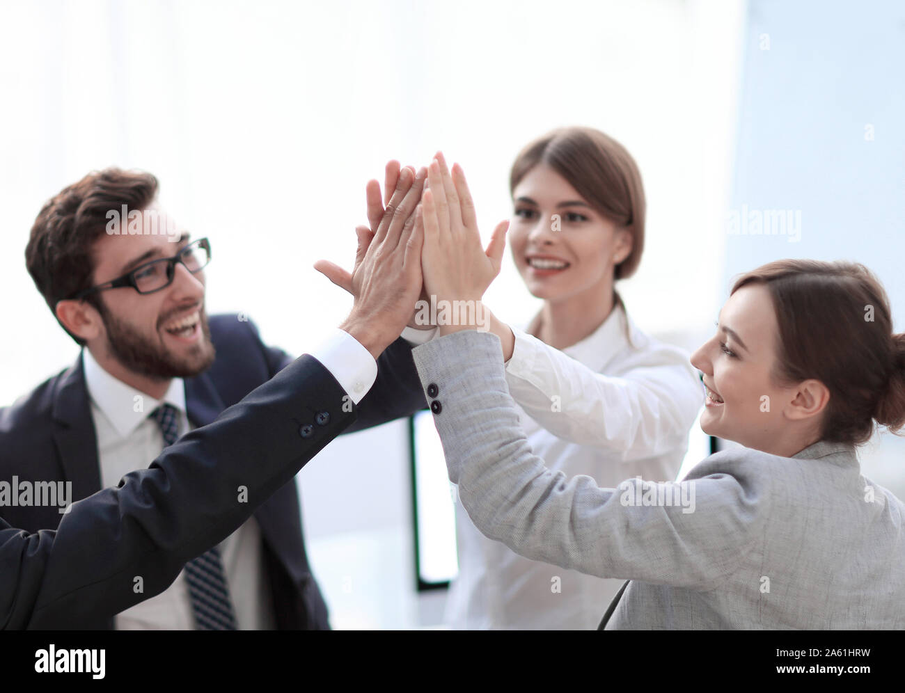 successful business team giving each other a high-five, standing in the ...