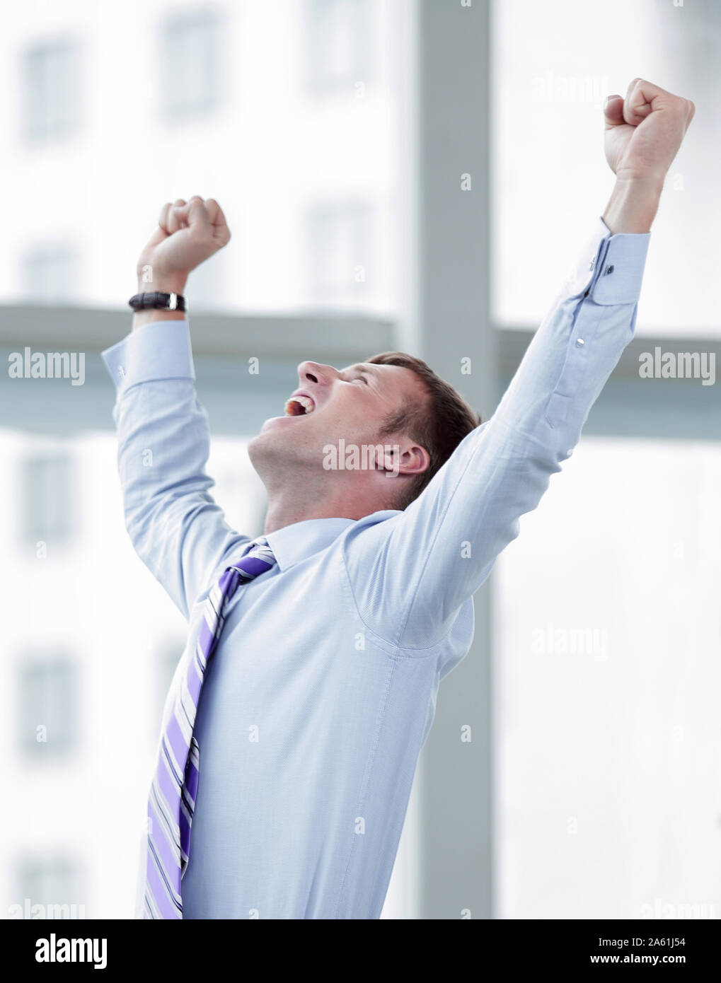 Businessman celebrating with his fists raised in the air Stock Photo ...