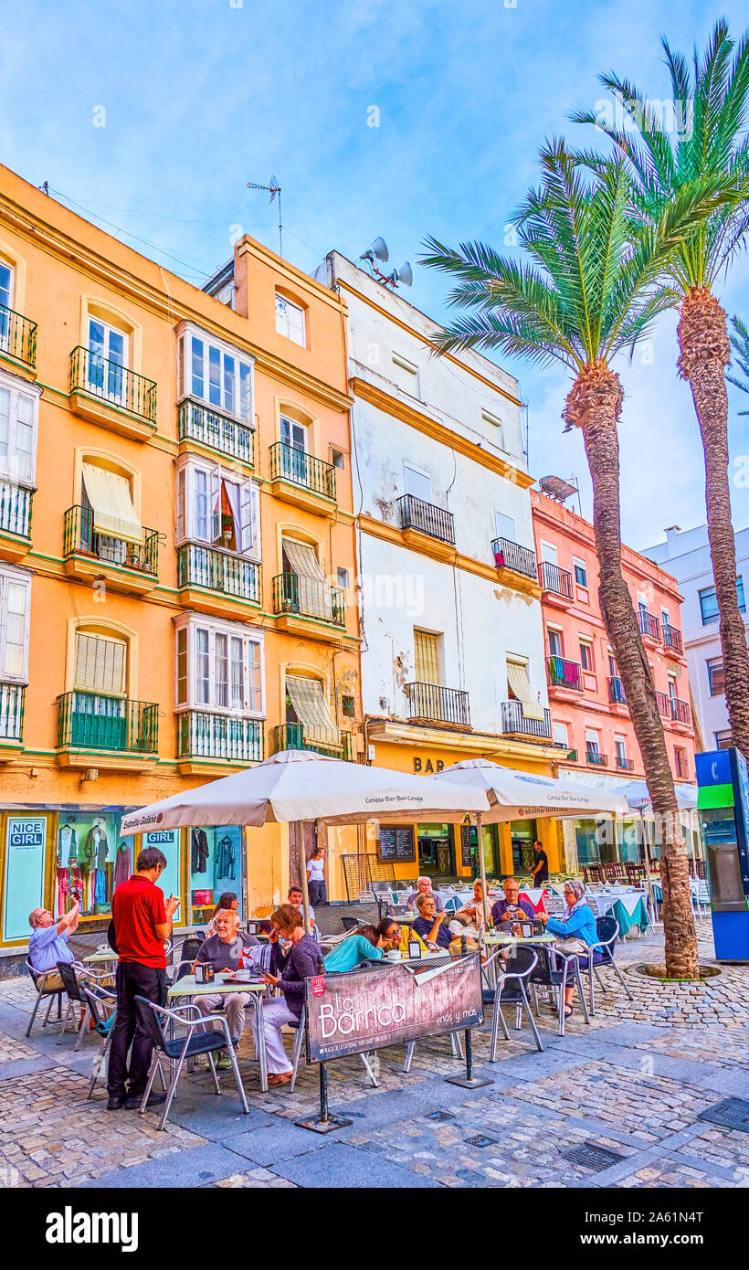 CADIZ, SPAIN - SEPTEMBER 19, 2019: Restaurants on Cathedral Square offer variety of traditional Andalusian dishes in the open air in summer terraces, Stock Photo