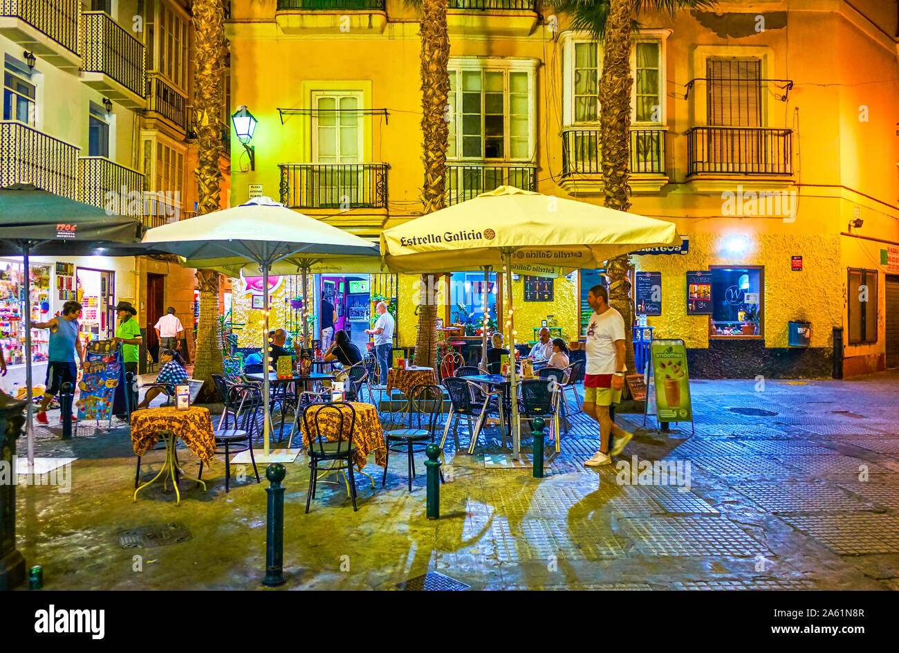 CADIZ, SPAIN - SEPTEMBER 19, 2019: The romantic dinner in a small outdoor restaurant in cozy Antonio Martin square in surrounding of medieval Andalusi Stock Photo