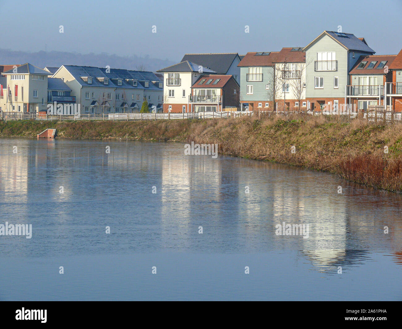Houses on the lagoon at the Watercolour housing development between Merstham and Redhill in winter Stock Photo