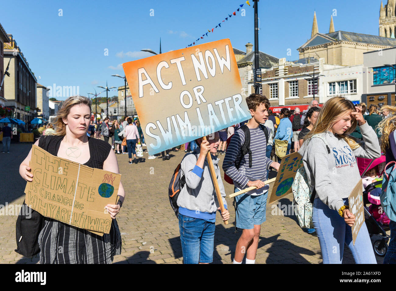Young people carrying placards participating in the Extinction Rebellion climate strike in Truro City City in Cornwall. Stock Photo