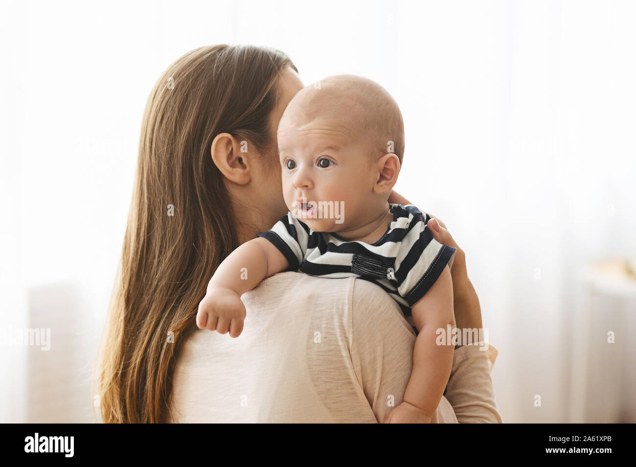 Mother patting adorable baby on back after breasfeeding Stock Photo Alamy