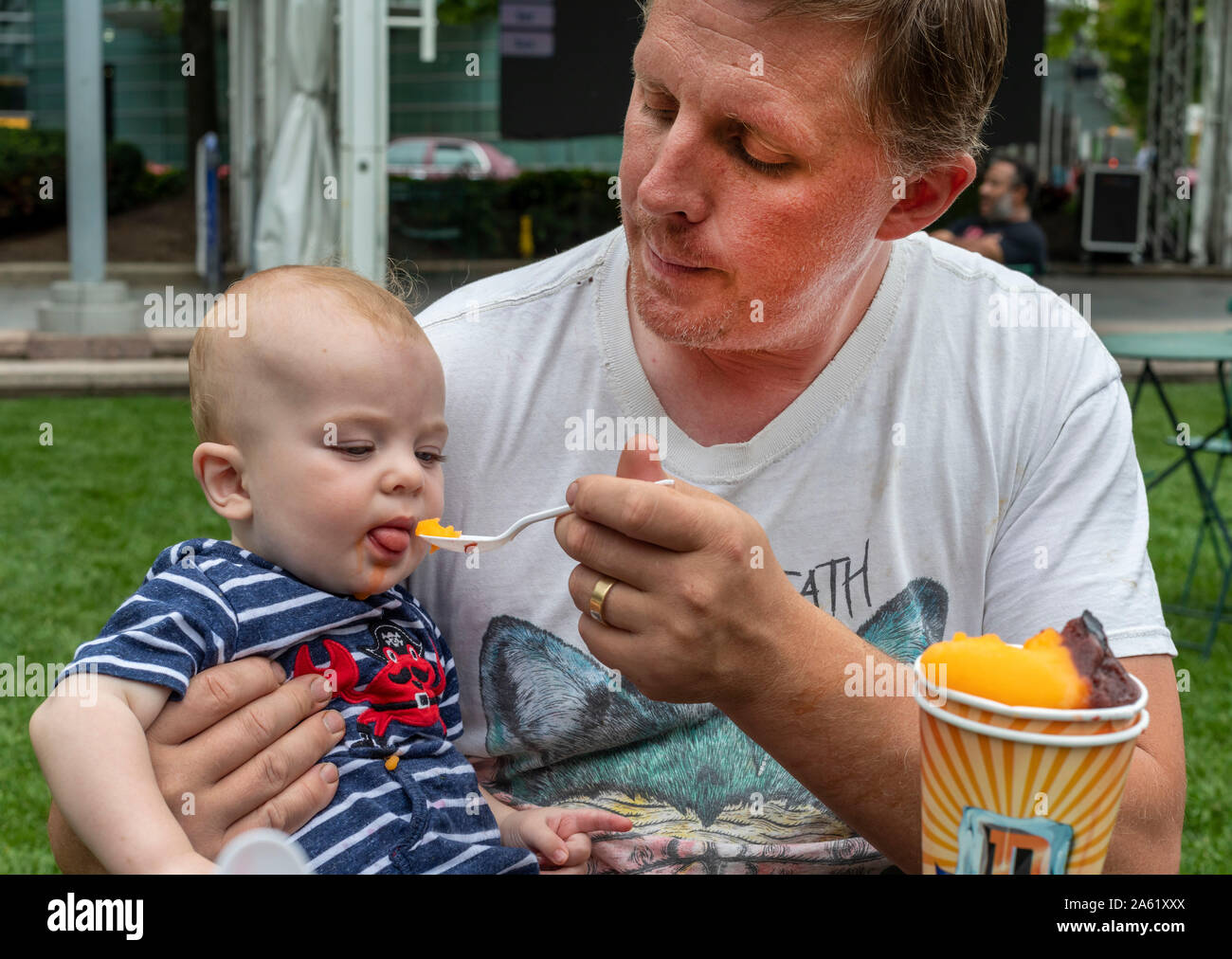 Detroit, Michigan - One-year-old Hendrix Hjermstad gets a treat from his dad, Adam Hjermstad Sr. Stock Photo