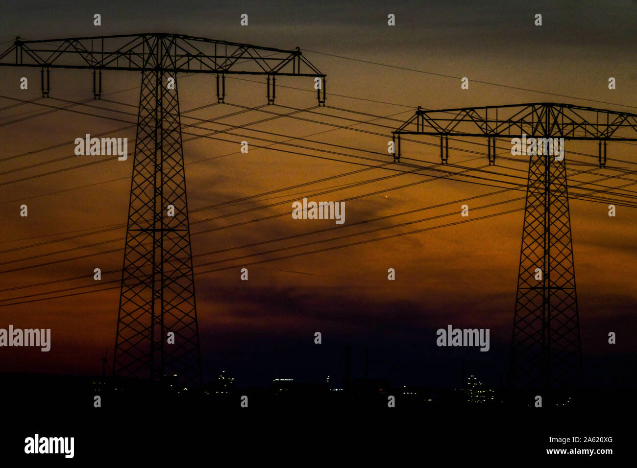 Power lines pylons at night Germany electricity wires, Transmission, Energy Stock Photo
