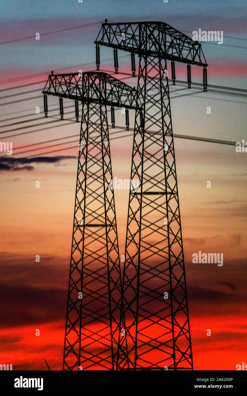 Power lines sunset Germany high high-voltage wires Transmission, Energy, Sunset sky pylons Stock Photo