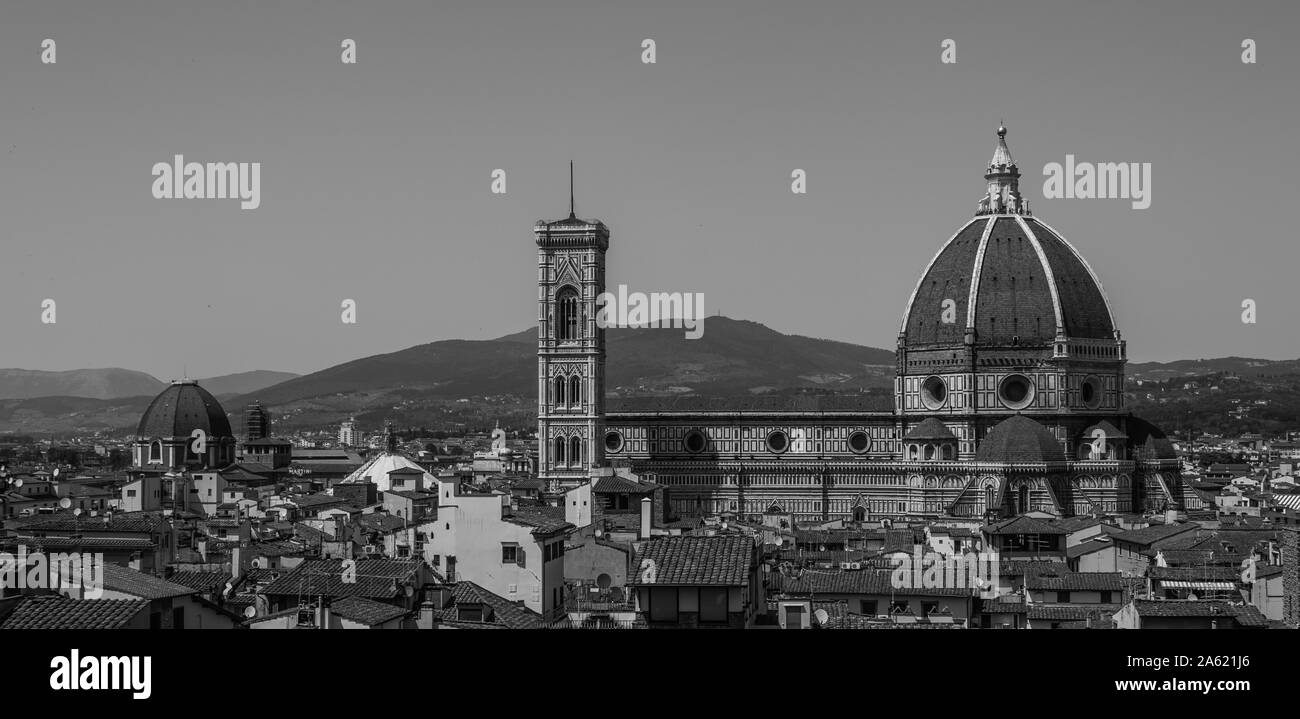 A black and white picture of the Cathedral of Santa Maria del Fiore above Florence's rooftops. Stock Photo